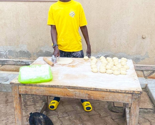 One of the boys making chapatis