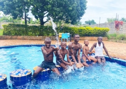 The younger boys at the charity playing in a pool