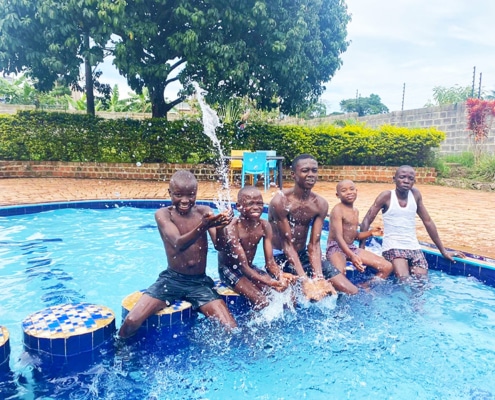The younger boys at the charity playing in a pool