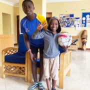 Two former street children with their new football