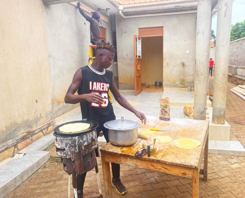 One of our former boys returning to cook chapatis