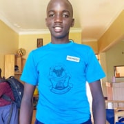 Another boys from the streets of Kampala now a school prefect