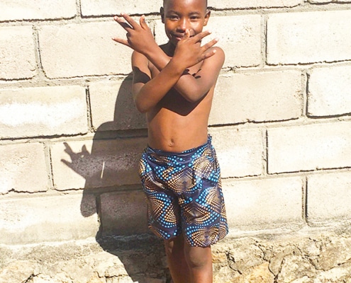 One of the charity boys wearing new home-made shorts