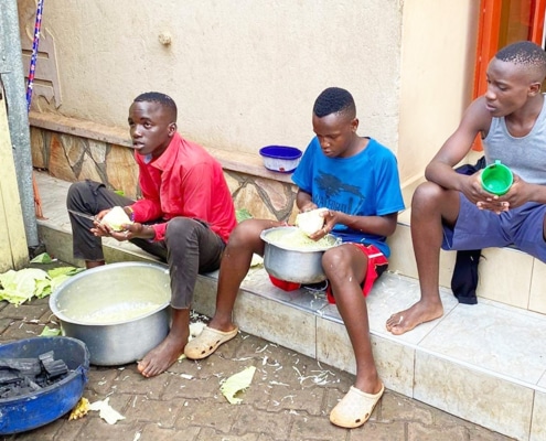 Former street boys helping to prepare a barbeque