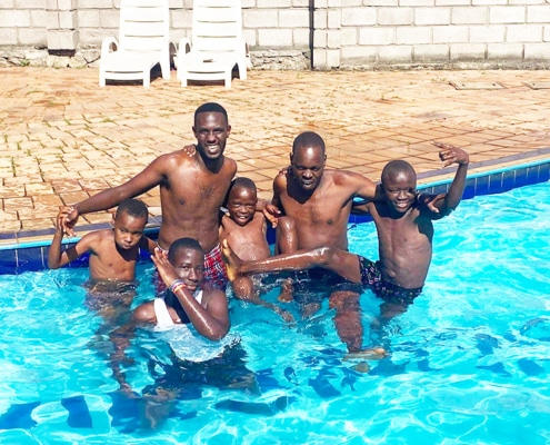 Boys and staff from the charity in the pool