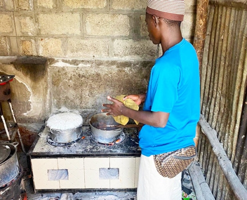 One of the former street boys cooking for everyone