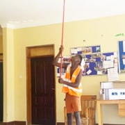 A former street boy cleaning at the charity