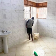 Street child now cleaning a bathroom at George's Place