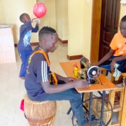 Former street boy in Uganda now mending clothes