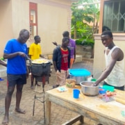 Former street boys from Kampala cooking together
