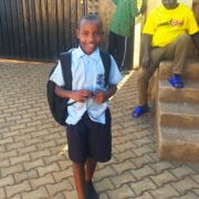 Another former street boy returning from school