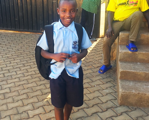 Another former street boy returning from school
