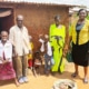 Jane and a charity worker visiting a family in Uganda