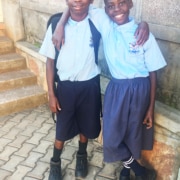 Two children from the streets of Kampala back from school