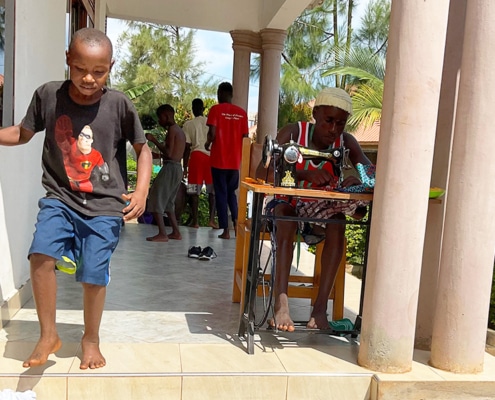 Two former street children making clothes