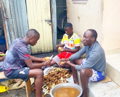 Three boys at the charity preparing dinner