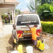 Two new boys at the charity washing the minibus