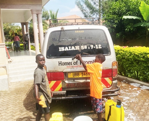 Two new boys at the charity washing the minibus