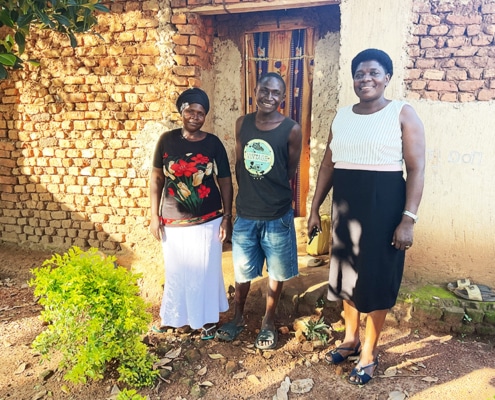 A former boy from the charity with his family in Bugiri
