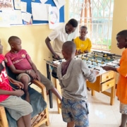 Charity working playing table football with the boys