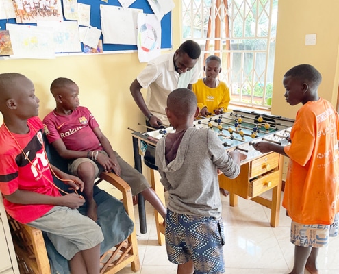 Charity working playing table football with the boys