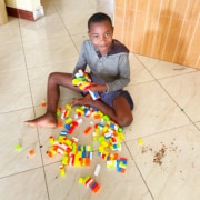 A boy at George's Place playing with Lego
