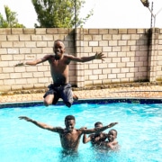 Former street children playing together in the pool