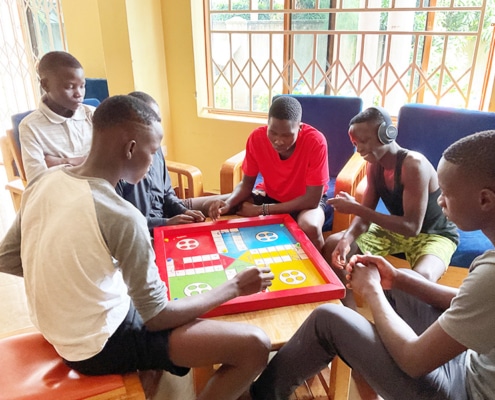 Former street children playing board games at the charity