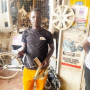 A street boy from Kampala now working at a garage