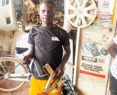 A street boy from Kampala now working at a garage