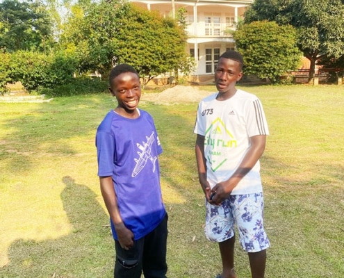 Two former homeless boys now at college in Uganda
