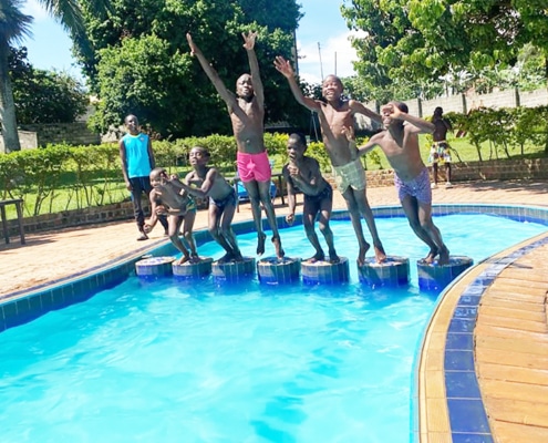 Boys from the charity at a swimming pool