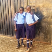 Two former street children return from school