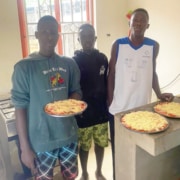 Three of the boys helping to cook at the charity