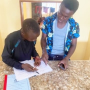 Former street boys helping each other with homework