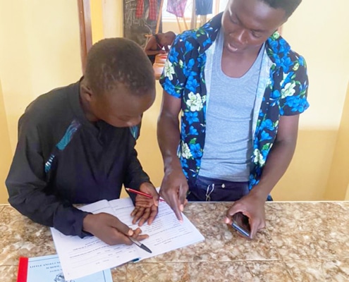 Former street boys helping each other with homework