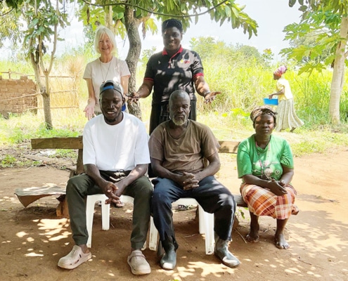 Jane and Peace visiting a family in Guju
