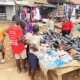 Boys buying sandals at a street market in Uganda