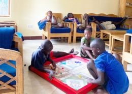 Former street children playing Ludo together in the charity home
