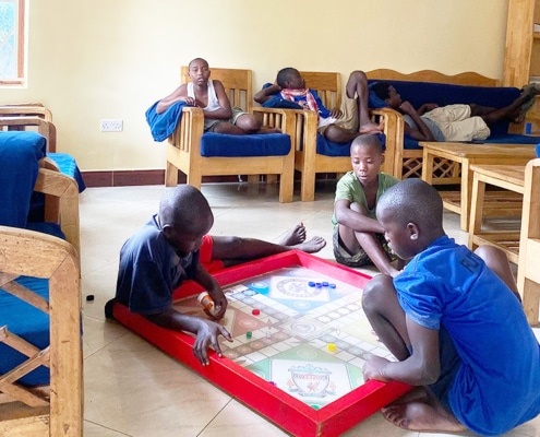 Former street children playing Ludo together in the charity home