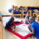 Former street children playing Ludo together in the charity home