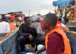 Boys from George's Place on a boat across the lake