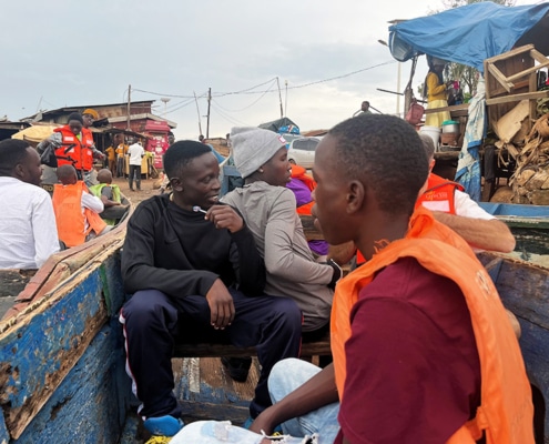 Boys from George's Place on a boat across the lake