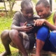 Two former street children playing with Jane's iPad