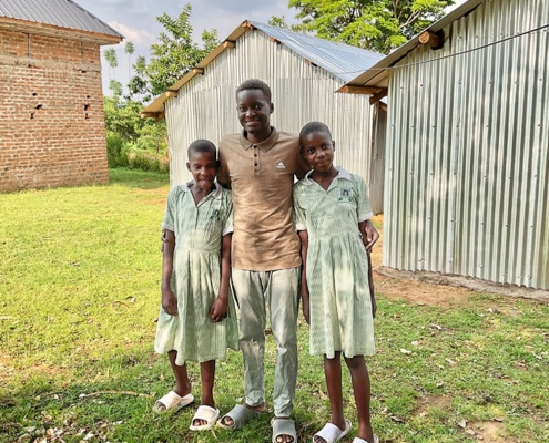 Former homeless boy with his sisters