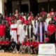 All the boys, clergy, and friends at the charity anniversary party outside the church