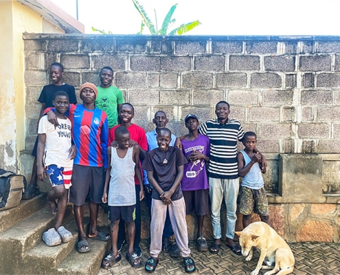 Boys at the charity home welcoming someone back