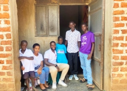 Charity workers with one of the boys and his family