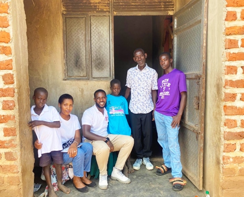 Charity workers with one of the boys and his family