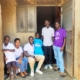 Charity workers with one of the boys and his family